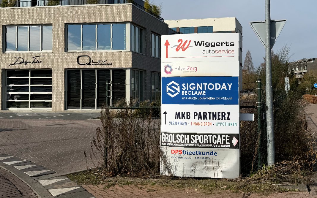 Reclamezuil met bedrijfsborden, waaronder Signtoday Reclame